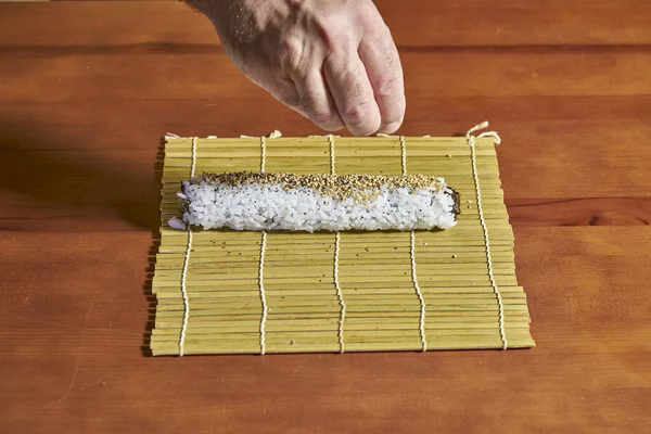 Cook Adds Poppy Seeds Piece Seaweed Rice Fish Already Rolled — Stock Photo, Image