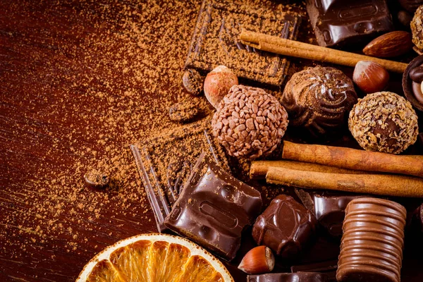 Barrette di cioccolato, tartufi di cioccolato, noci, spezie e anelli di arancia essiccati — Foto Stock