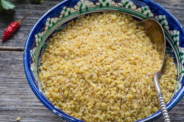 Close up view of bulgur grains in authentic bowl — Stock Photo, Image