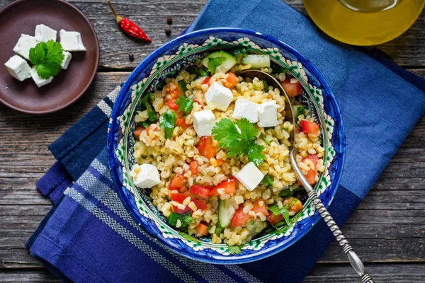 Tabbouleh salad in bowl on textile, top view — Stock Photo, Image