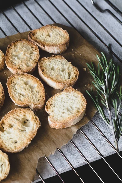 Crostini with rosemary on cooling rack