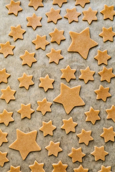 Stars shaped gingerbread cookies on parchment paper