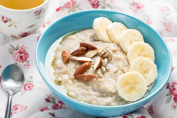 Oatmeal porridge with bananas, nuts, seeds and honey