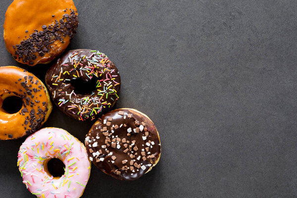 Glazed donuts on dark background