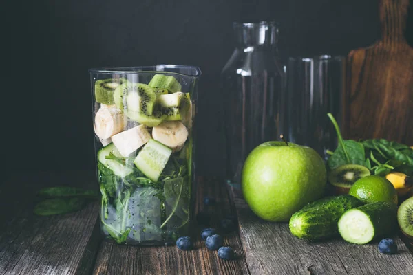 Green smoothie ingredients on dark wooden table — Stock Photo, Image