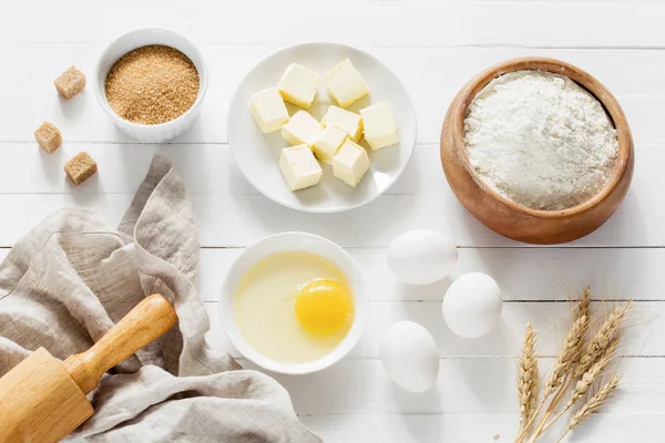 Baking bread / cake ingredients on white wooden table