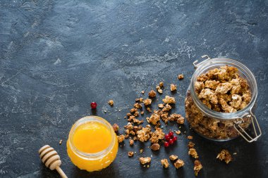 Granola ve bal koyu arka plan üzerinde