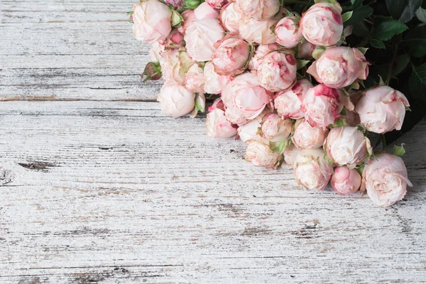 Kopya alanı metin için vintage ahşap zemin üzerine pembe çalı gülleri