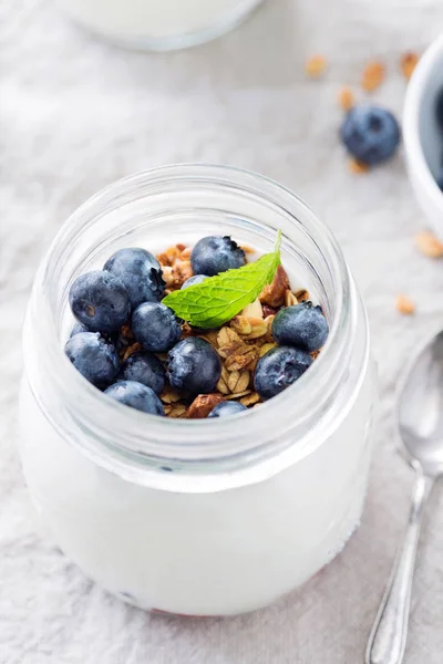 Greek yogurt with blueberries and granola in a jar