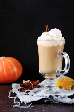 Coffee with whipped cream and cinnamon or pumpkin spice latte in mug