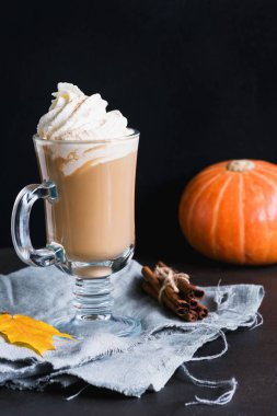 Coffee with whipped cream and cinnamon or pumpkin spice latte in mug