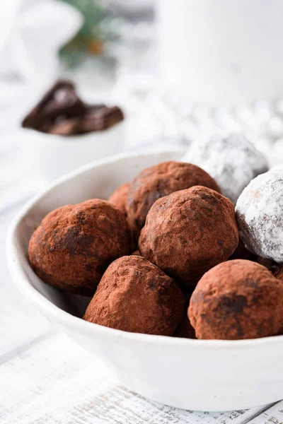 Chocolate truffles in white bowl on white table — Stock Photo, Image