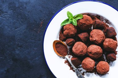 Koyu çikolata truffles beyaz tabakta. Tablo Üstten Görünüm