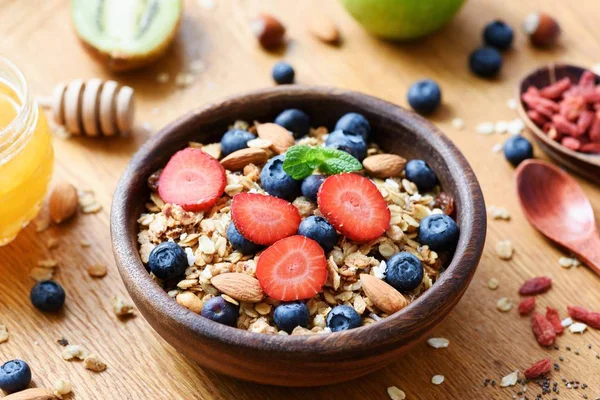 Granola bowl with fresh blueberry strawberry and nuts