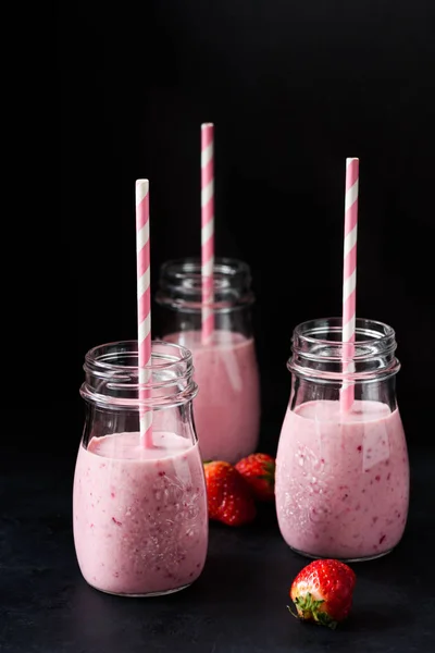 Fresh strawberry smoothies on black background — Stock Photo, Image