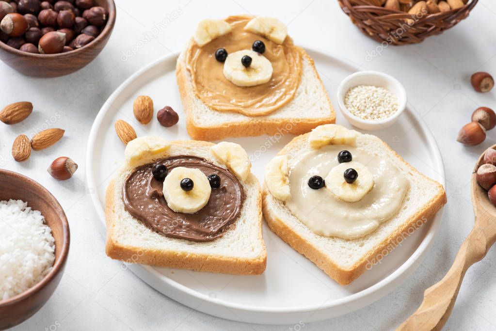 Vegan nut butter toasts with animal faces. Healthy breakfast for kids