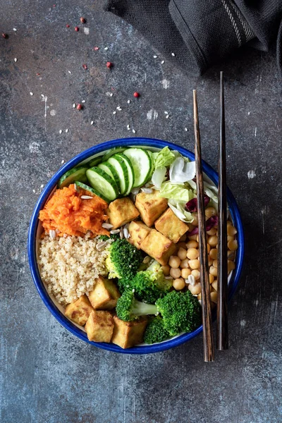 Salad with quinoa, tofu, broccoli, chickpeas and vegetables. Buddha bowl