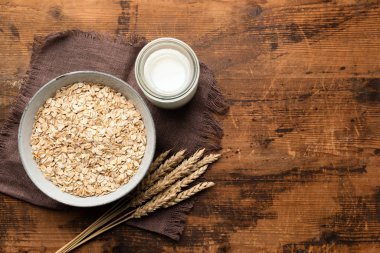 Yuvarlanmış yulaf, yulaf ezmesi ve ahşap masada yulaf sütü.