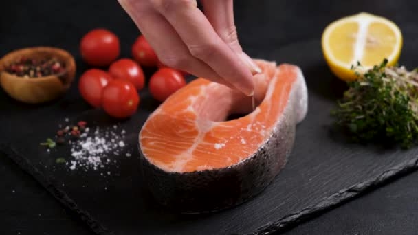 Woman Chef Sprinkle Sea Salt Fresh Salmon Steak Black Slate — Stock Video