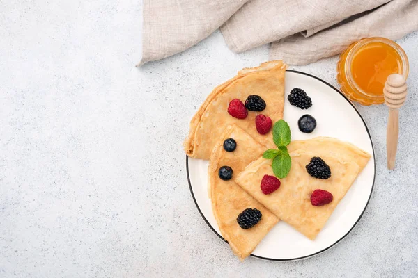 French Crepes With Summer Berries and Honey On Plate — стокове фото