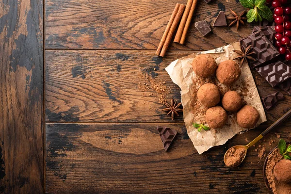 Homemade chocolate truffles with spices on wooden table — Stock Photo, Image