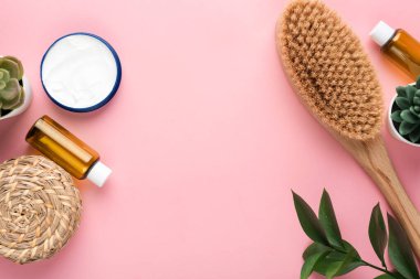 Beauty and spa cosmetic objects flat lay on pink background