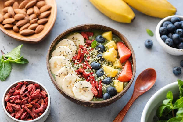 Vegan raw hemp smoothie bowl with fruits, nuts and seeds