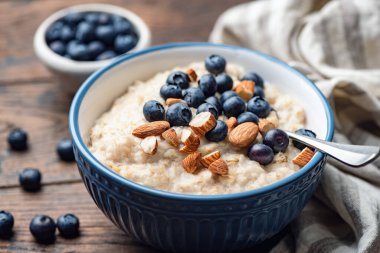 Oatmeal porridge with blueberries and almonds clipart