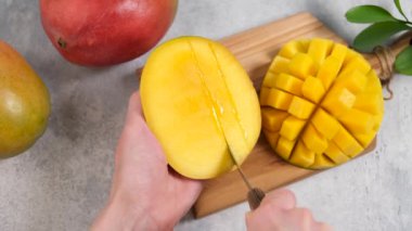 Taze olgun mangoları küp küp doğramak. Mango video eğitiminin nasıl kesileceği