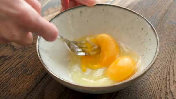 卵をフォークでゆっくりと混ぜる動き 卵を叩く 調理プロセス オムレットやスクランブルの準備 — ストック動画