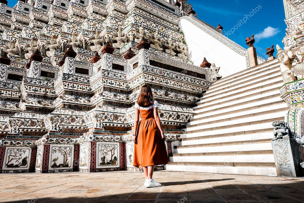 Brown skirt girl With the Prang of Arun Temple, Wat arun Bangkok Thailand.