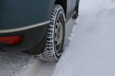 Kışın, derin bir karda yol alan bir geçitin çarkları.