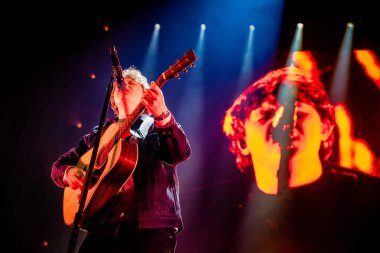 AMSTERDAM, NETHERLANDS - FEBRUARY 13, 2020: Lewis Capaldi playing guitar while show at AFAS Live concert hall.