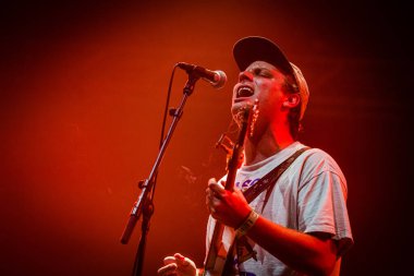 Mac DeMarco performing on stage during  music festival clipart
