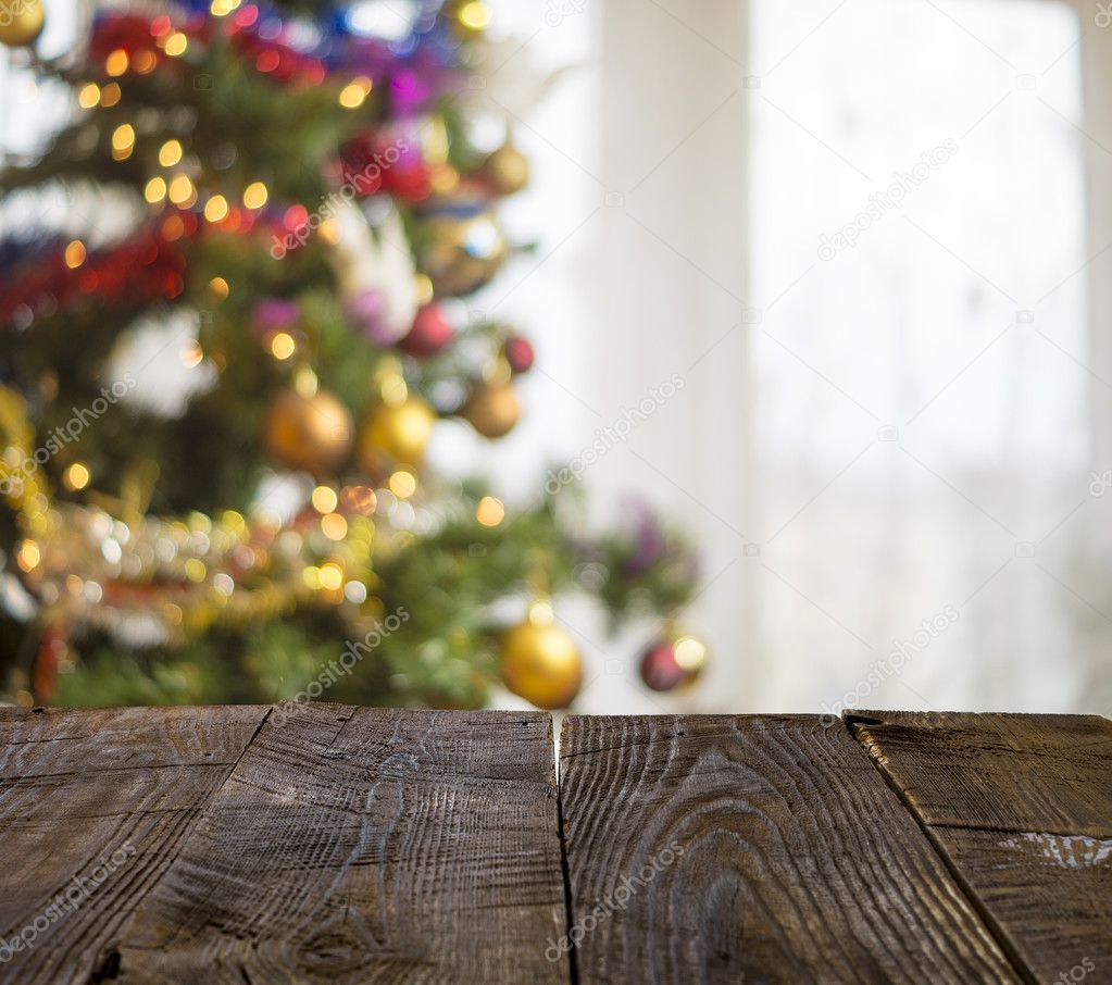 christmas table background with christmas tree out of focus