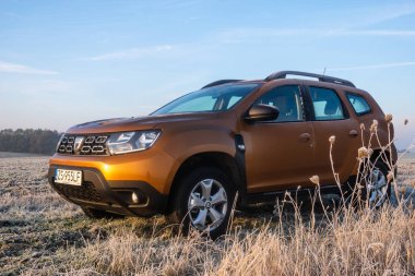 SUV Dacia Duster on a frosted meadow  clipart
