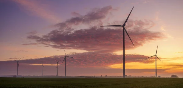 Windmills on the field during a beautiful sunrise — 스톡 사진