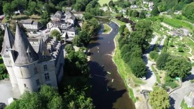 Belçika 'nın Durbuy kentindeki eski kasaba ve kalenin havadan görünüşü, yaz mevsiminde nehirdeki dağlar, nehirler ve kayakçılarla çevrili. Şehrin Panoraması