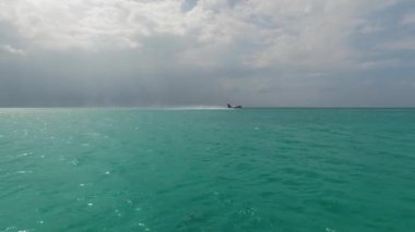 Deniz uçağı ya da deniz uçağı Maldivler ya da Seyşeller Adası 'ndaki bir suya iniyor.. 