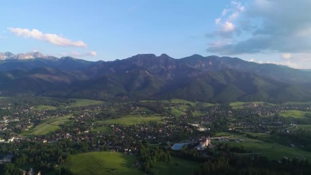 夏には谷の山や町の空中ビュー ポーランドのタトラ山脈にあるギウント山塊と夏のザコパネのパノラマ — ストック動画