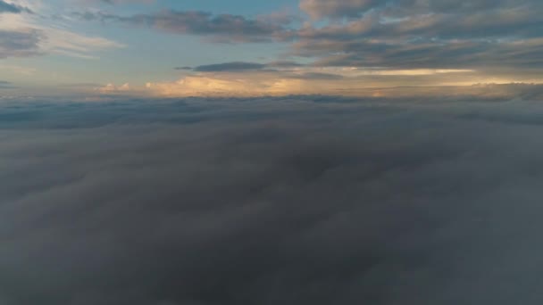 日の出の間に雲の上を飛んで空中ビュー ふわふわの雲が動く風景 無人機は高く飛んでいる ロゴやテキストの完璧な背景 雲の上の平面視 成層圏 — ストック動画