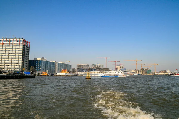 Construction works in Amsterdam with boats floating on the water