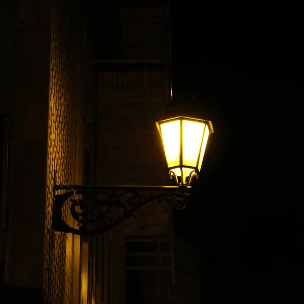 A street lamp at night with the light. Faro, Portugal.