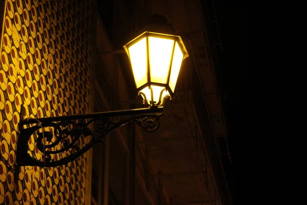 A street lamp at night with the light.