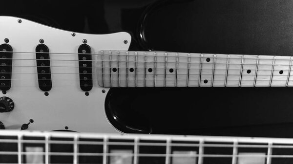 Two electric guitar closeup . black and white
