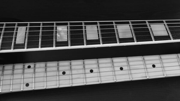 Two electric guitar necks closeup . black and white
