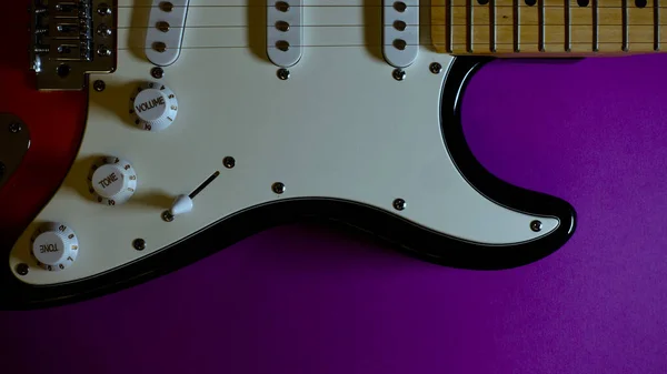 electric guitar closeup . Purple background