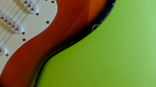 electric guitar closeup . Green background
