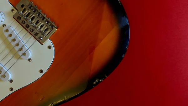 electric guitar closeup  . Red background