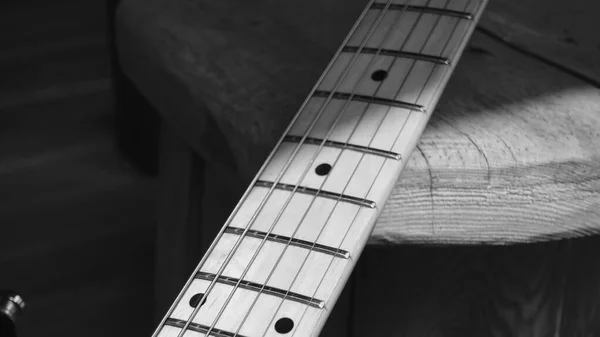 electric guitar closeup on the wooden boards  . Black and white